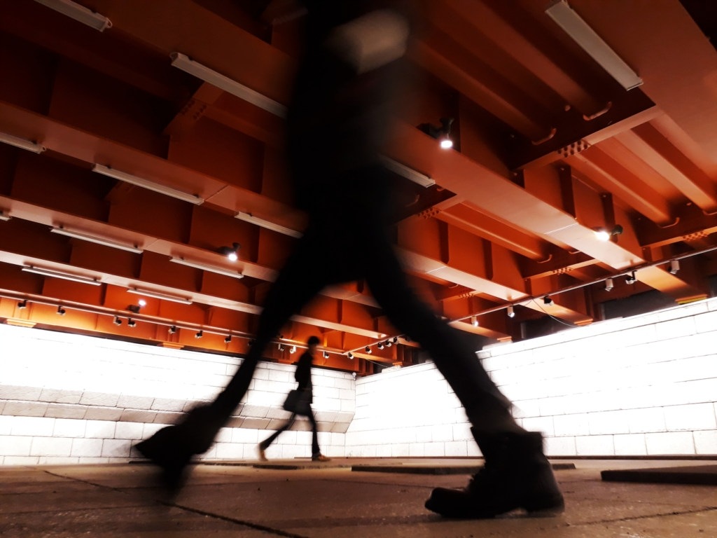 Pedestrians commuting to and from work through a downtown underground walkway.
