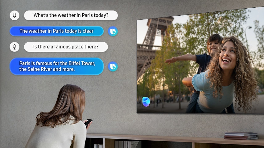 Une femme dans un salon parle à Bixby par le téléviseur. Les légendes du dialogue sont affichées. Quel temps fait-il à Paris aujourd’hui ? Le temps à Paris est dégagé aujourd’hui. Y a-t-il un endroit célèbre là-bas ? Paris est célèbre pour la tour Eiffel, la Seine et bien plus encore.