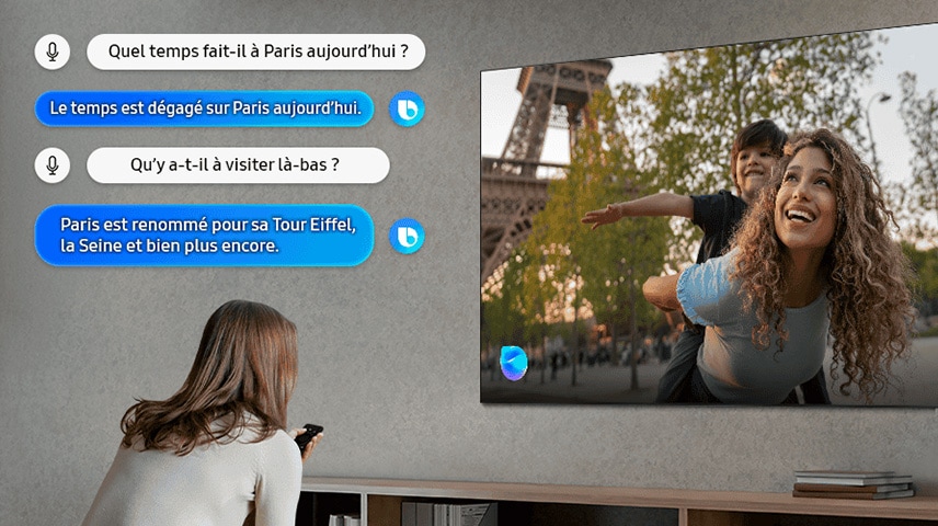 Une femme dans un salon parle à Bixby sur sa TV. Les sous-titres de dialogue apparaissent. Quel temps fait-il à Paris aujourd'hui ? Le temps est clair à Paris aujourd'hui. Y a-t-il un lieu célèbre à Paris ? Paris est célèbre pour la Tour Eiffel, la Seine et bien plus encore.