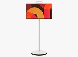 A Samsung The Movingstyle LSM7F TV displays abstract shapes in red and yellow tones on screen.