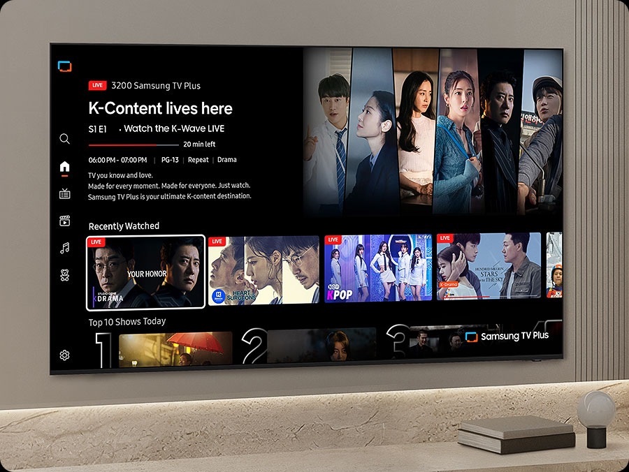 TV in a living room shows Samsung TV Plus home screen and the diverse TV channels available with it. 