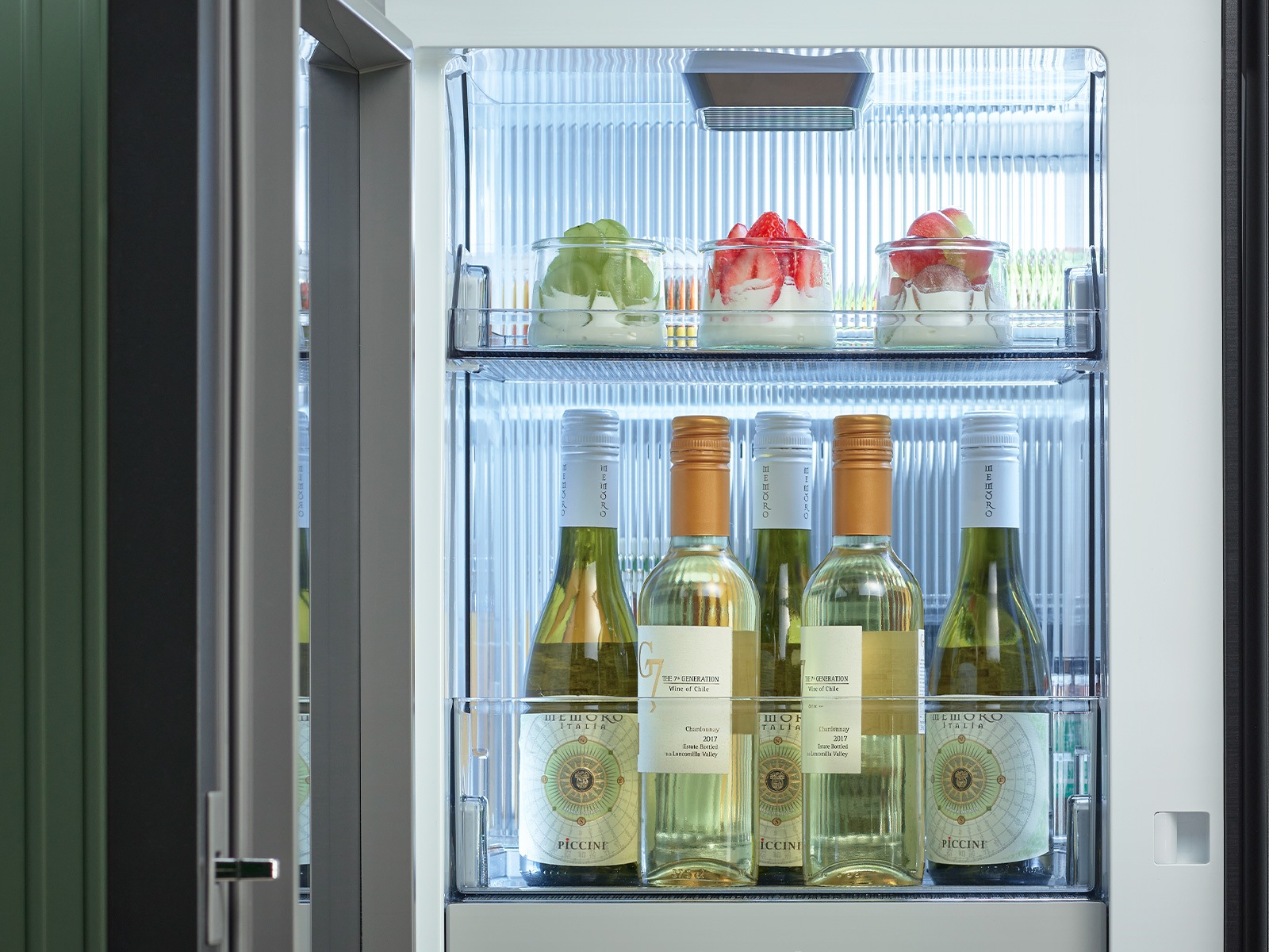 Inside view of Samsung Bespoke 4-Door Flex White Glass Refrigerator stocked wine bottles